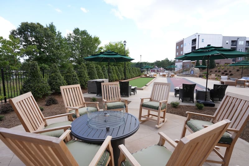 Courtyard seating beside shuffleboard and putting green