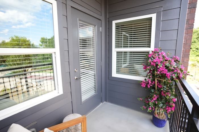 Private balcony of an apartment at Park Place by Highlands with patio seating and a potted plant