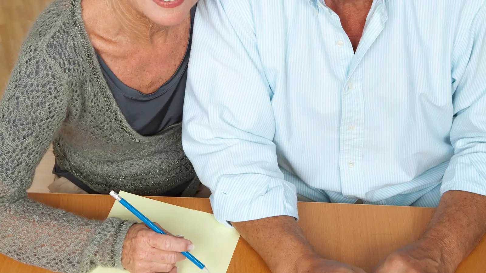 Older couple reviewing written housing information at a table